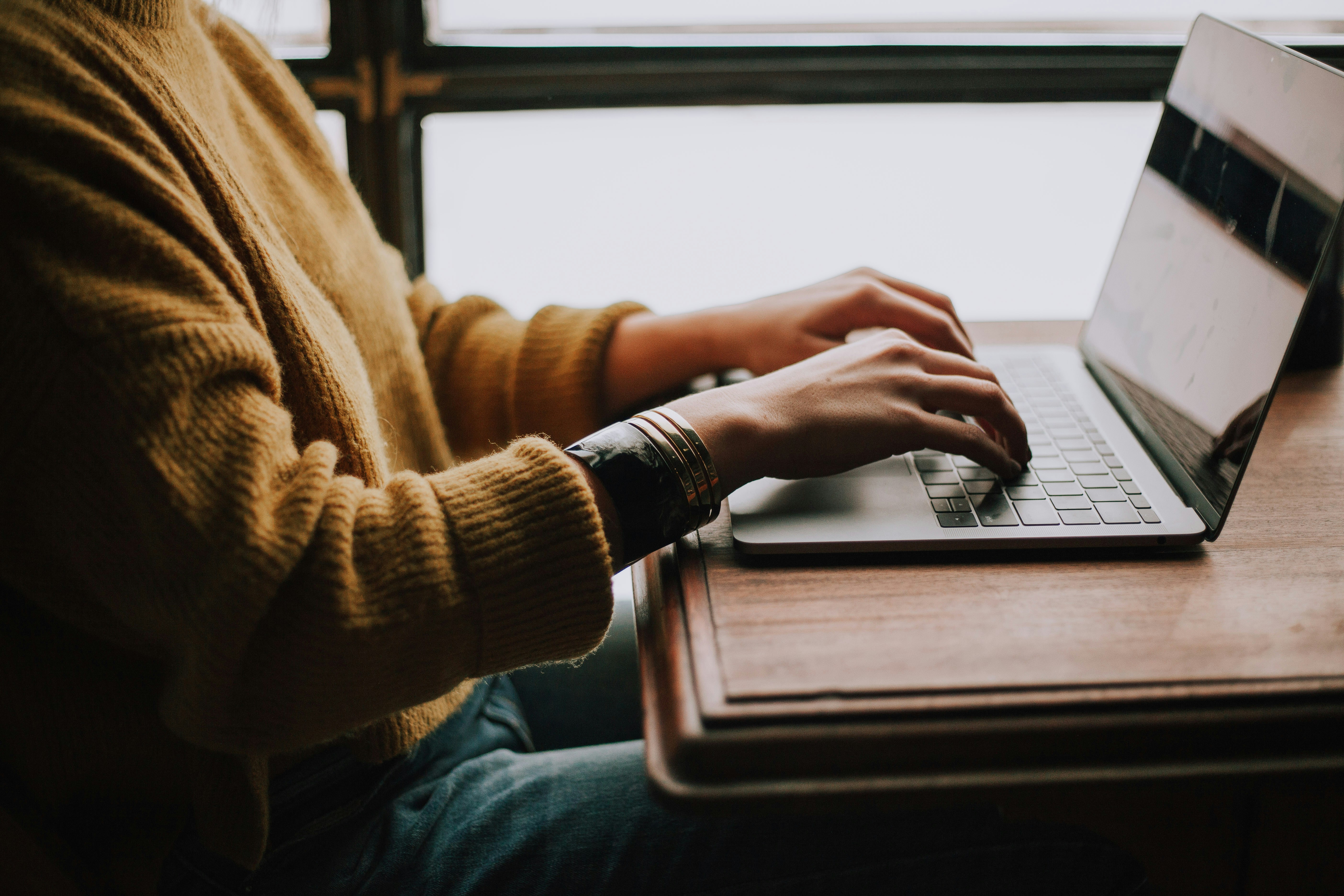 Close up of a person typing on laptop